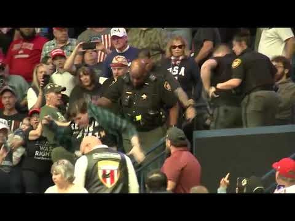 Deputies moving in as the scuffle breaks out in the stands at the Youngstown rally